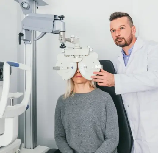 Doctor checking women's eye with the machine.